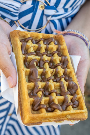 A delicious waffle with hazelnut chocolate creamの写真素材