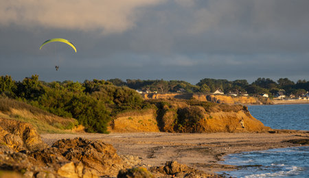 Paraglider flying above a beautiful French coastの写真素材