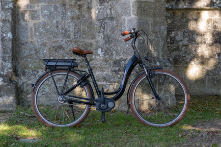 Retro black bicycle by and old stone buildingの写真素材