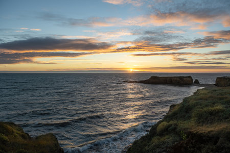 Sun setting in the sea in a beautiful Britton coastの写真素材