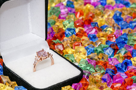Ring in a jewelry box on background of multicolored gems for texture and wallpaperの写真素材
