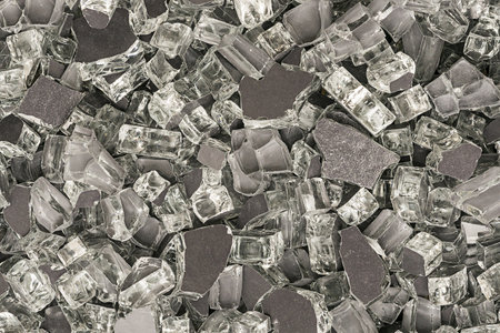 Background fragmented with dark broken glass or dark crushed glass for textureの写真素材
