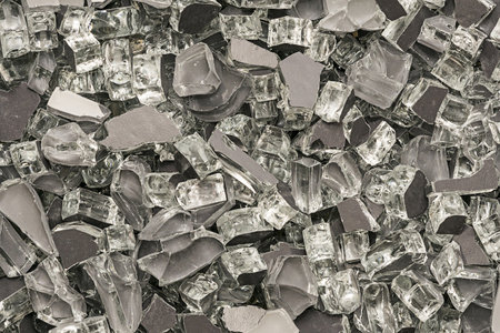Background fragmented with dark broken glass or dark crushed glass for textureの写真素材