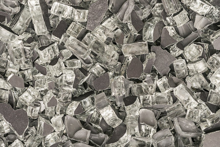 Background fragmented with dark broken glass or dark crushed glass for textureの写真素材