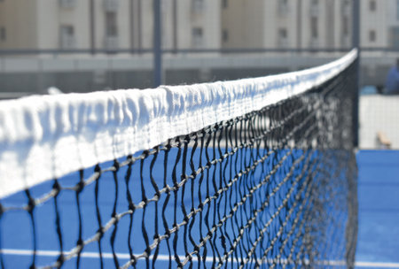 Padel sport court blue white net perspective zoom in metal cage Sunset tennis grass turfの写真素材