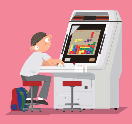 A schoolboy playing video game in arcade game centre