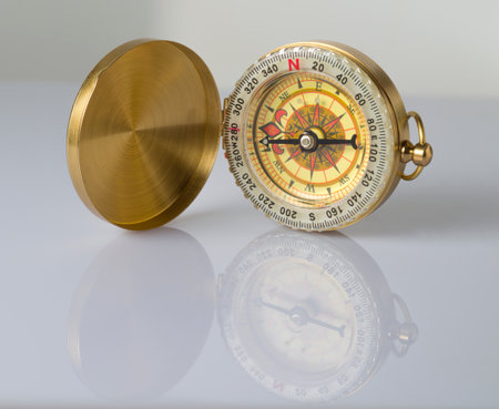 Golden vintage compass, isolated on white background