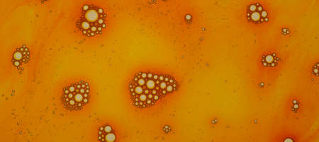 Orange bubbles banner, soap foam with orange liquid. Close up of texture. Flat lay top view