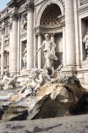 The monumental complex of the Trevi Fountain in Rome, with its statues and water between the rocks          の写真素材