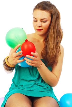 A young woman while playing with balloonsの写真素材
