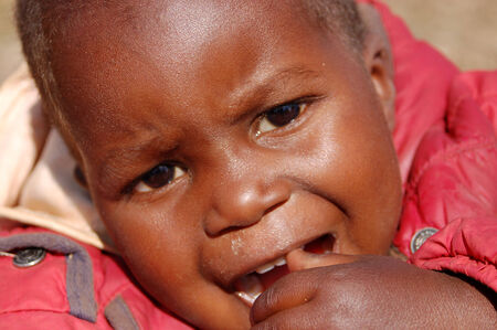 Africa -Tanzania - Village Pomerini - august 2013 - The Franciscan Mission for Humanitarian Aid - The look on the faces of the children of Africa, many of them sick with AIDS, a look for the futureのeditorial素材