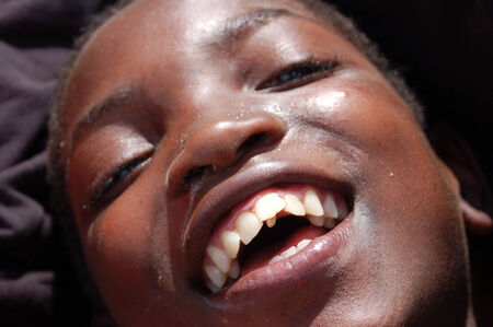 Africa -Tanzania - Village Pomerini - august 2013 - The Franciscan Mission for Humanitarian Aid - The look on the faces of the children of Africa, many of them sick with AIDS, a look for the futureのeditorial素材