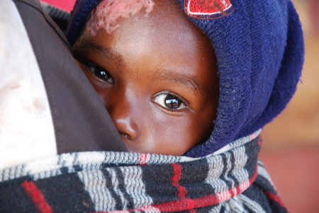 August 2014 - Africa -Tanzania - Moments of everyday life in the Village of Pomerini  affected by AIDS. Between a past of misery and poverty and a future of hope contained in children's eyesのeditorial素材