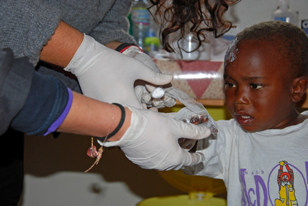August 2014-Village of Pomerini-Tanzania-Africa-The intervention of medical first aid of volunteer nurses in the infirmary of the Franciscan Mission of the Village of Pomerini in Tanzania.のeditorial素材