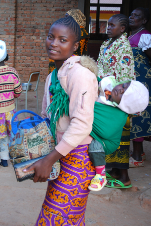 August 2014 - Village of Pomerini - Tanzania - Africa - An African woman with her child received into the Franciscan Mission of Pomerini for Humanitarian Aid for Aidsのeditorial素材
