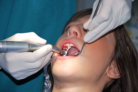 A young woman sitting in a dental office will submit to medical supervisionの写真素材