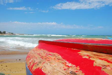 Boats pulled ashore on the coast of Apulia Torre Canne - Puglia - Italyの写真素材