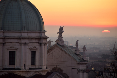 The dome of Brescia Cathedral in backlight at sunset - Brescia - Lombardy - Italyの写真素材