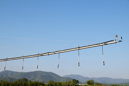 A giant spray sprinkler to wet a newly plowed fieldの写真素材