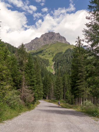 A healthy walk on the mountain path in the valley below Monte Blumone, Bresciaの写真素材