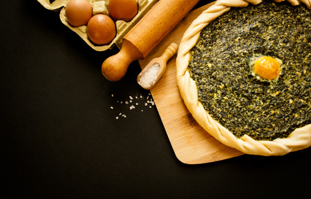 spinach savory pie displayed with some ingredientsの写真素材