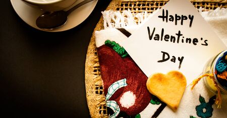 valentine's card displayed with a heart-shaped butter cookieの写真素材