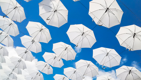 texture of white umbrellas on a blue sky backgroundの写真素材