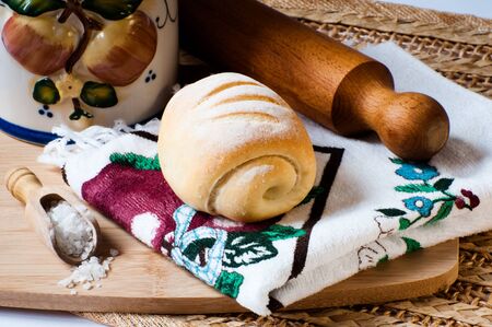 kamut bread on a kitchen cloth near salt and a rolling pin