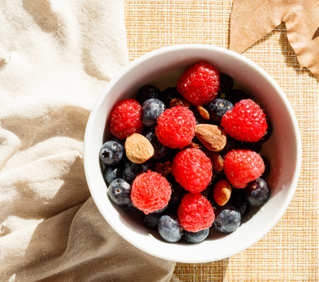 Autumn style breakfast with red fruits, nuts, honey, milk and toastの写真素材