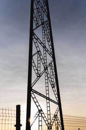 silhouette of electric tower with the sky in the backgroundの写真素材