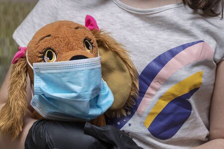 covid-19 protecting your stuffed animal from the pandemic. Children also feel that they have to protect what they love most.の写真素材