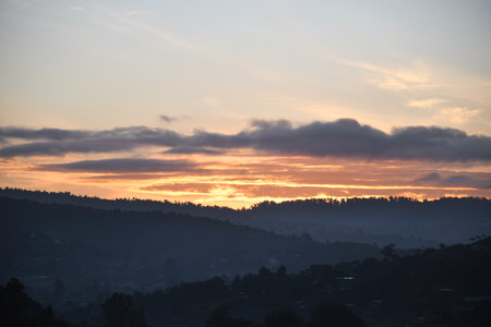 Sunrise in the mountains with silhouette of a village in the background, Maralal town early morningの写真素材