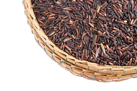 Rice berry in bamboo basket isolate on whiteの写真素材