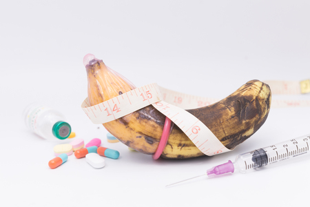 rotten banana in condom with hand injection,sexually transmitted disease conceptの写真素材