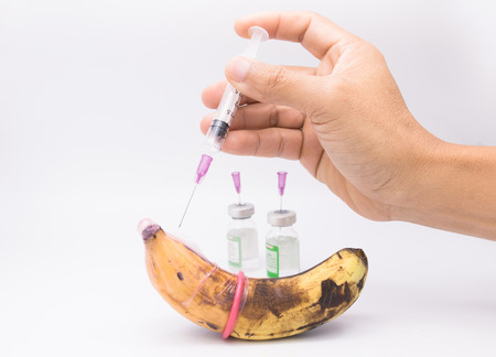 rotten banana in condom with hand injection,sexually transmitted disease conceptの写真素材