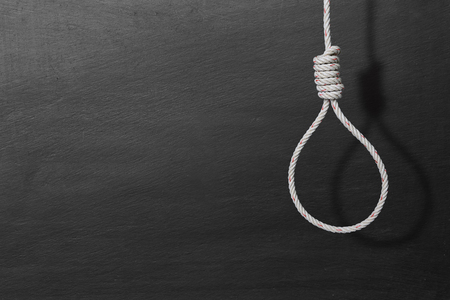 loop of rope and shadow for hanging with copy space for text on blackboard background  , concept of...