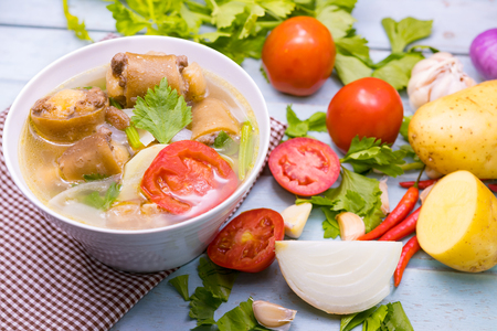 Oxtail soup in white dish on blue  table, Delicious halal foodの写真素材