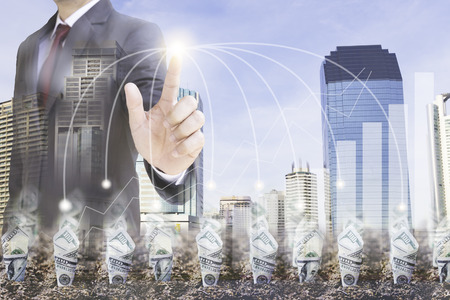 Dollar bill plant growth from ground over  city background. Double exposure. Business finance Partnership  and investment conceptの写真素材