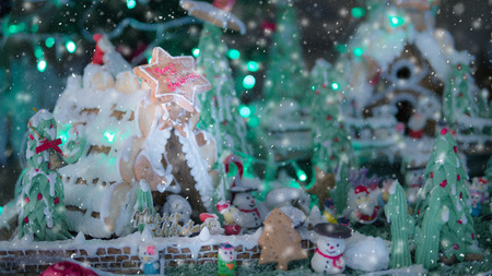 Christmas food background  snowmen cookies on snowy wooden background with Christmas tree branch blank space for textの写真素材