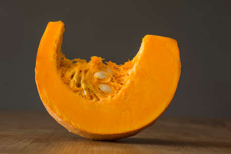 Slice pumpkin on wooden table, gray backgroundの写真素材