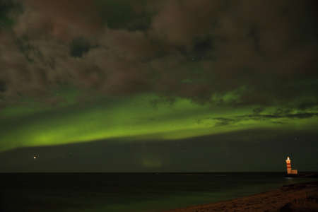 Aurora above the lighthouse on Gardskagi, Keflavik, Icelandの写真素材