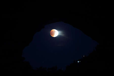lunar eclipse in window of North and South Windows, Arches National Park, Utah, USAの写真素材