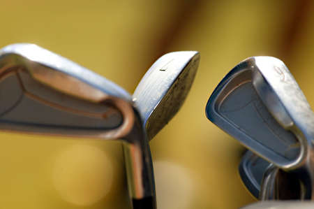 Three golf irons or golf clubs in the light. Three golf irons or golf clubs in the lightの写真素材