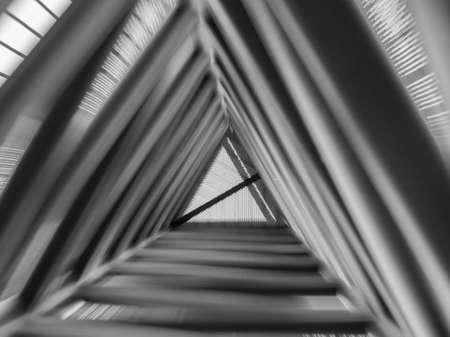 Zoom effect looking up through triangle structureの写真素材