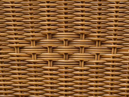 Closeup shot of a pattern on the back of a reed thatch chair