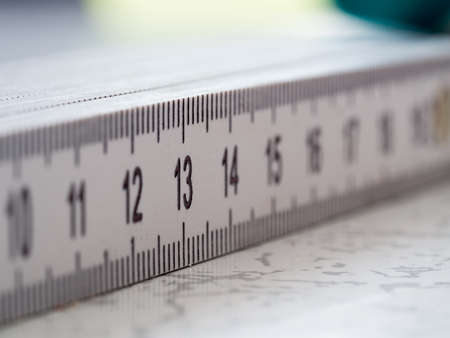Creative macro shot with focus on numer 13 on a white plastic rulerの写真素材