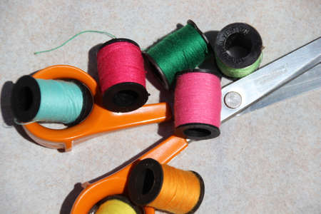 Photo taken of colored sewing thread and scissors