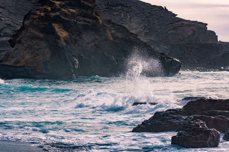 Breaking waves at the coast by El Golfo, Lanzarote, Canary islands, Spainの写真素材