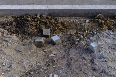 Construction site of a sidewalk with single paving stonesの写真素材