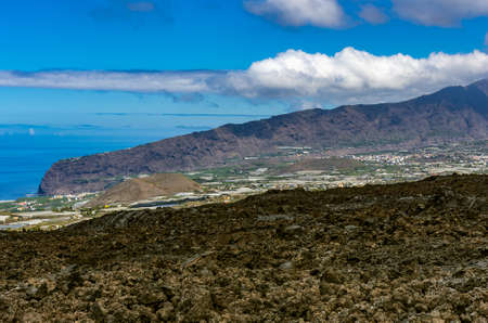 View over a lava field to the coast of La Palma and Tazacorteの写真素材